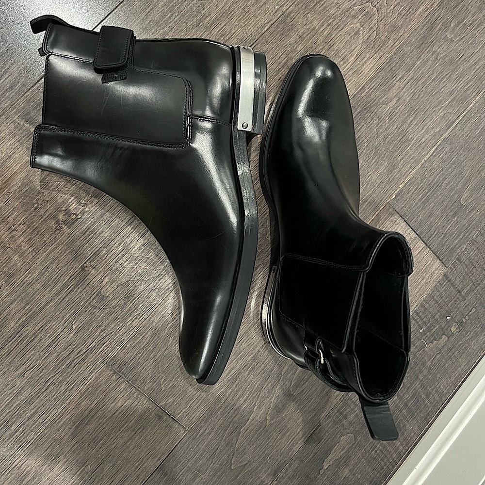 BALMAIN Black bullskin ankle boots Leather straps, silver logo engraved panel